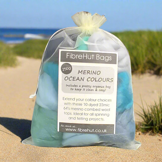 Bag of merino wool tops with a label on a beach
