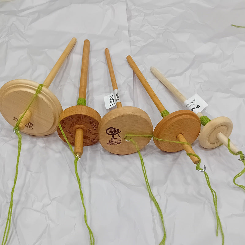 A drop spindle is a fun way to try hand spinning. The spindle is spun, adding twist to the wool fibres which are then drafted and wound onto the shaft as yarn.